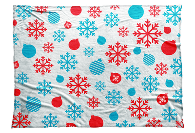 Red and blue snowflakes and Christmas ball ornaments decorate this seasonal blanket.